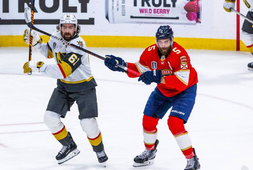 Golden Knights right wing Mark Stone (61) takes a stick from Florida Panthers defenseman Aaron ...