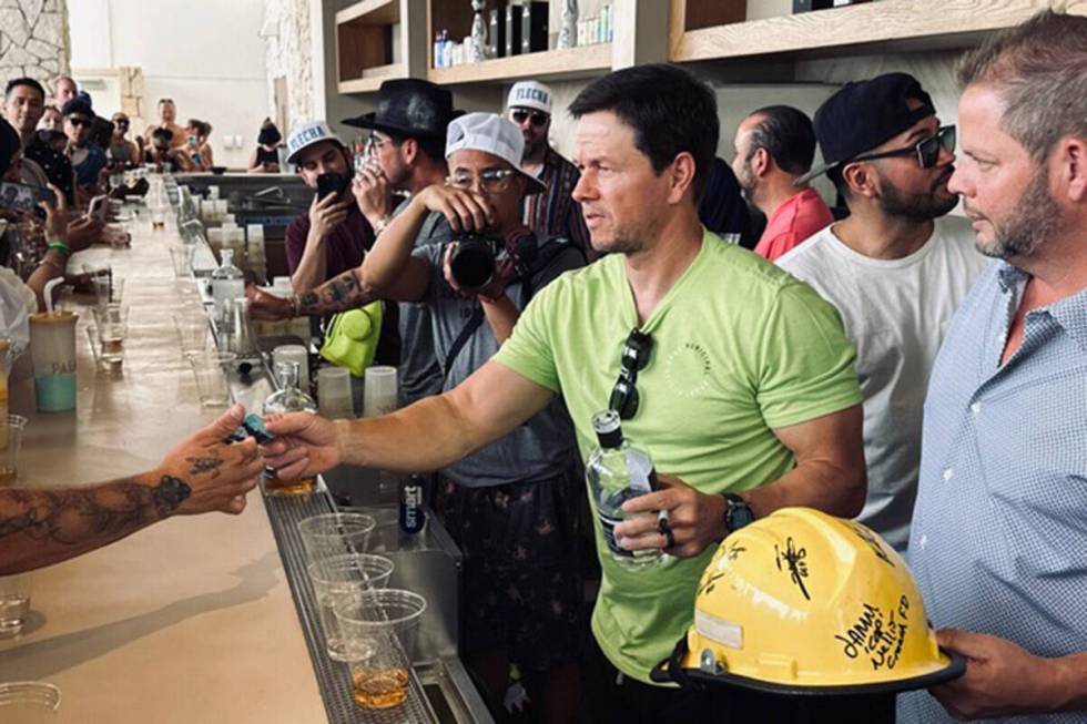 Actor and entrepreneur Mark Wahlberg is shown pouring shots of his Flecha Azul tequila at KAOS ...
