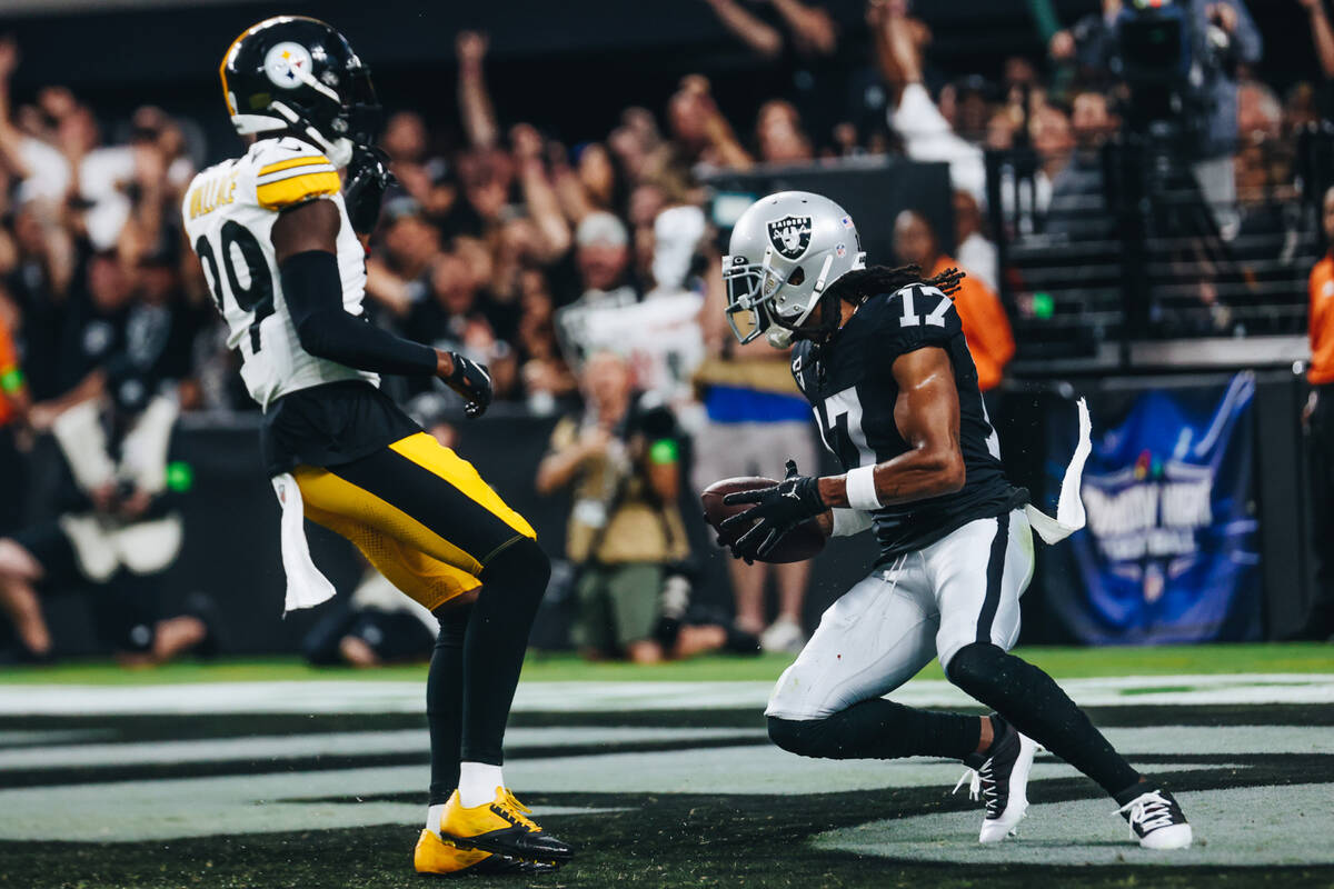 Raiders wide receiver Davante Adams (17) makes a touchdown during the first half of a game agai ...