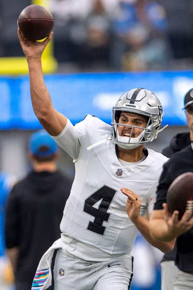 Raiders quarterback Aidan O'Connell (4) throws before an NFL game against the Los Angeles Charg ...