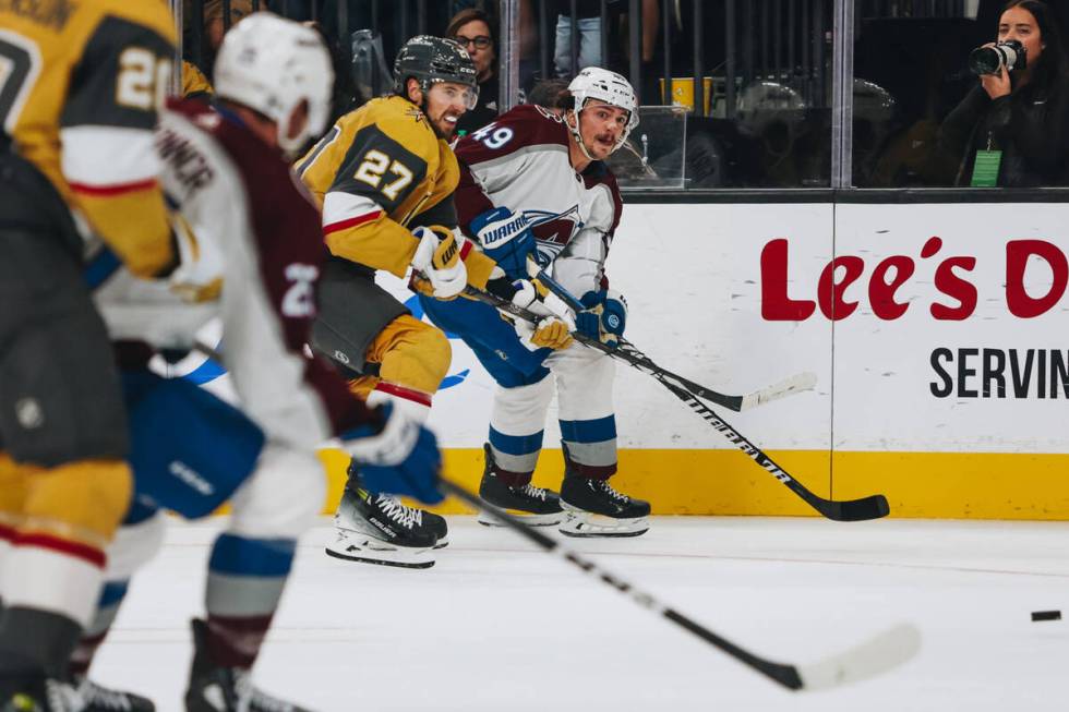 Colorado Avalanche defenseman Samuel Girard (49) eyes the puck as it escapes him and Golden Kni ...