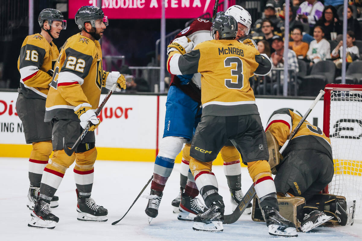 Golden Knights defenseman Brayden McNabb (3) shoves Colorado Avalanche forward Riley Tufte (10) ...