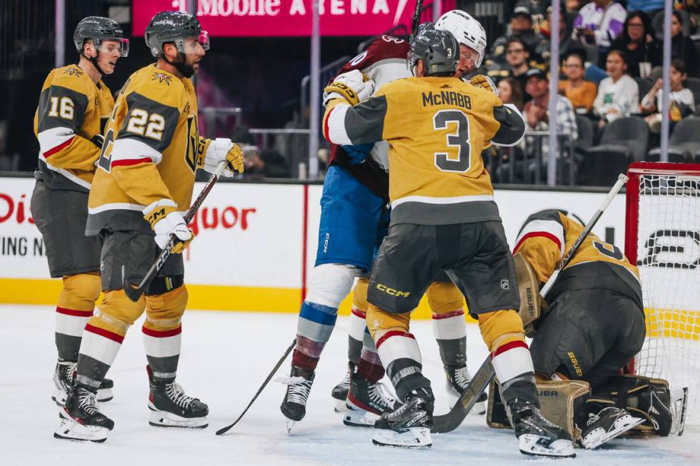 Golden Knights defenseman Brayden McNabb (3) shoves Colorado Avalanche forward Riley Tufte (10) ...