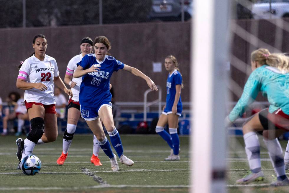 Bishop Gorman's Hunter Borgel (24) attempts a goal while Liberty defender Leilani Harworth (22) ...