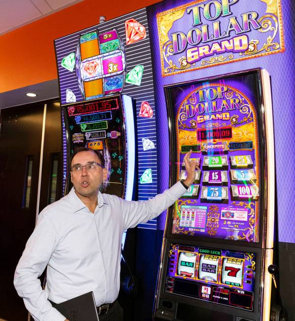 Nick Khin, a COO of Gaming for IGT, demonstrates how Top Dollar Grand and Diamond Jackpots Doub ...