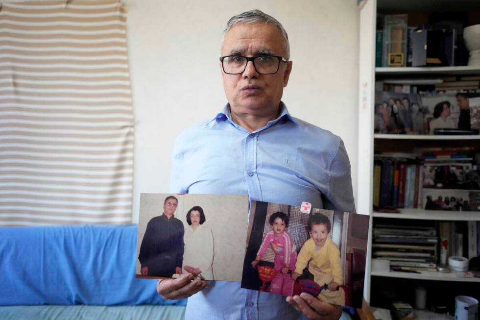 Narges Mohammadi's husband Taghi Rahmani shows a picture of him and his wife, and one of their ...