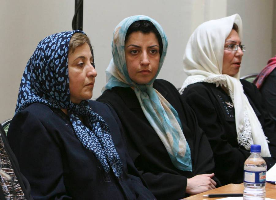 FILE - Prominent Iranian human rights activist Narges Mohammadi, center, sits next to Iranian N ...