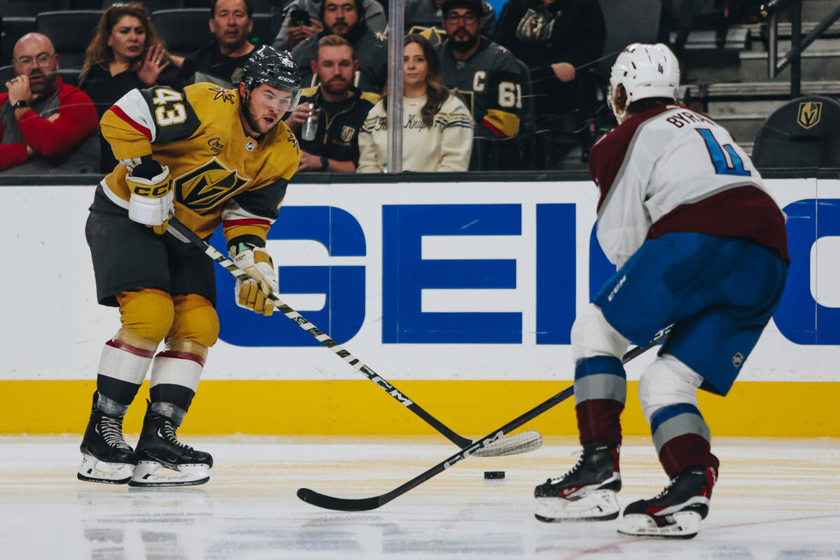 Golden Knights center Paul Cotter (43) and Colorado Avalanche defenseman Bowen Byram (4) race f ...