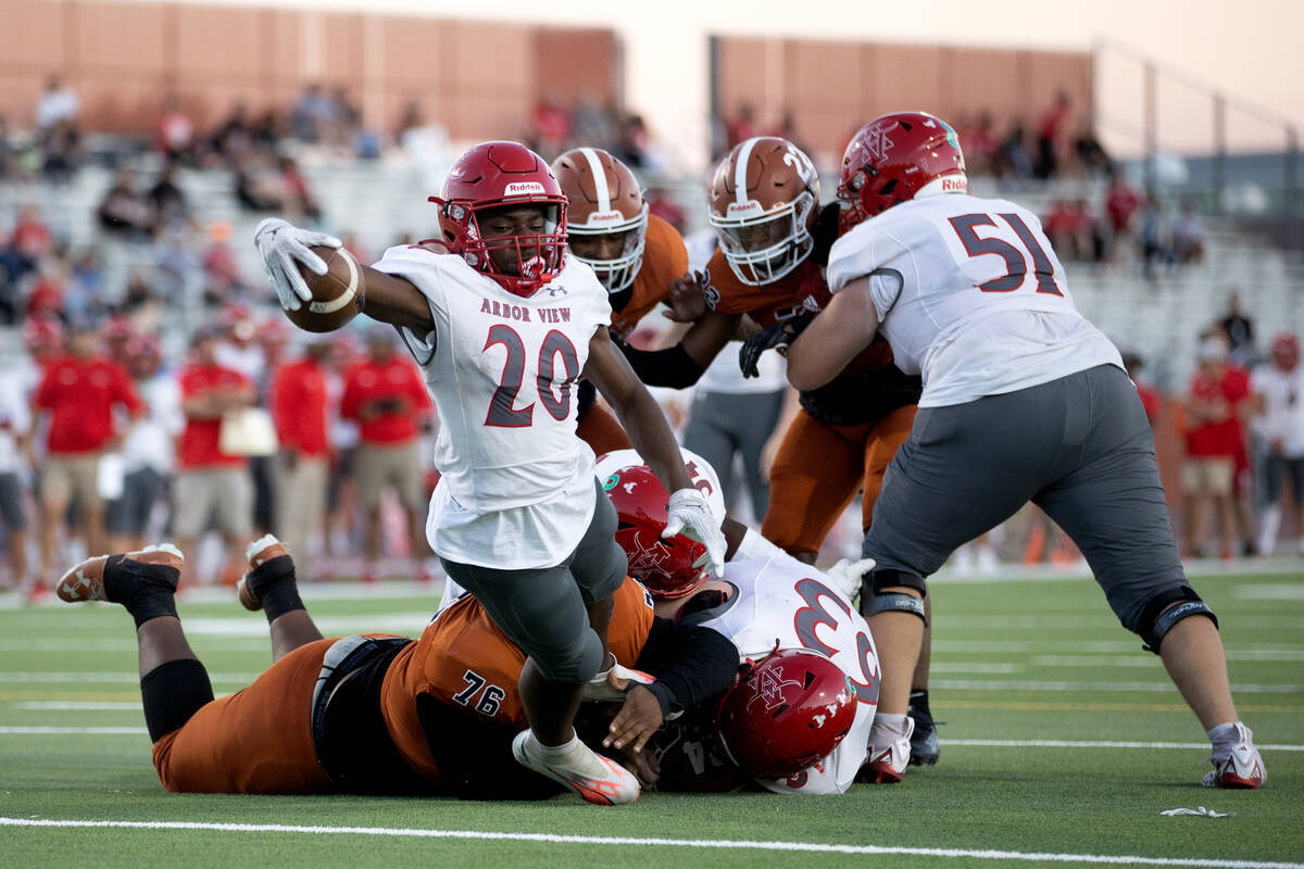 Arbor View running back Kamareion Bell (20) dives into the end zone for a touchdown while Legac ...