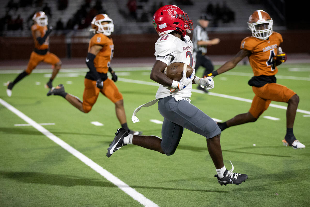 Arbor View running back Sean Moore (21) makes a significant gain against Legacy’s defens ...