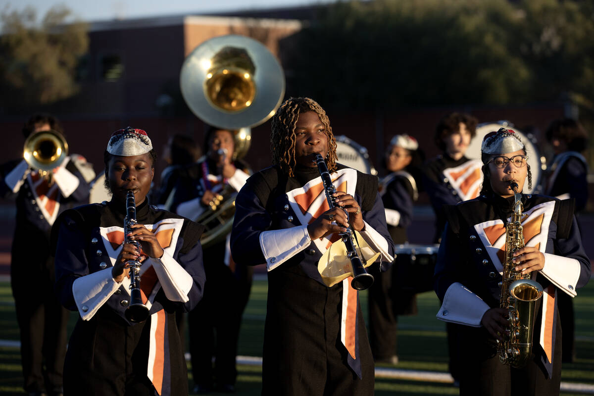The Legacy band plays the National Anthem before high school football game between Legacy and A ...