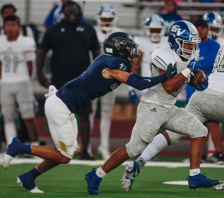 Green Valley wide receiver Theo Edquilang (6) muscles his way down the field with the ball duri ...