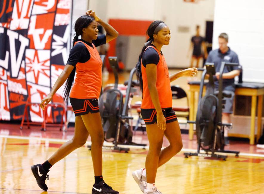 UNLV Lady Rebels center Desi-Rae Young, left, and Macie James (20) walk off the court after tea ...