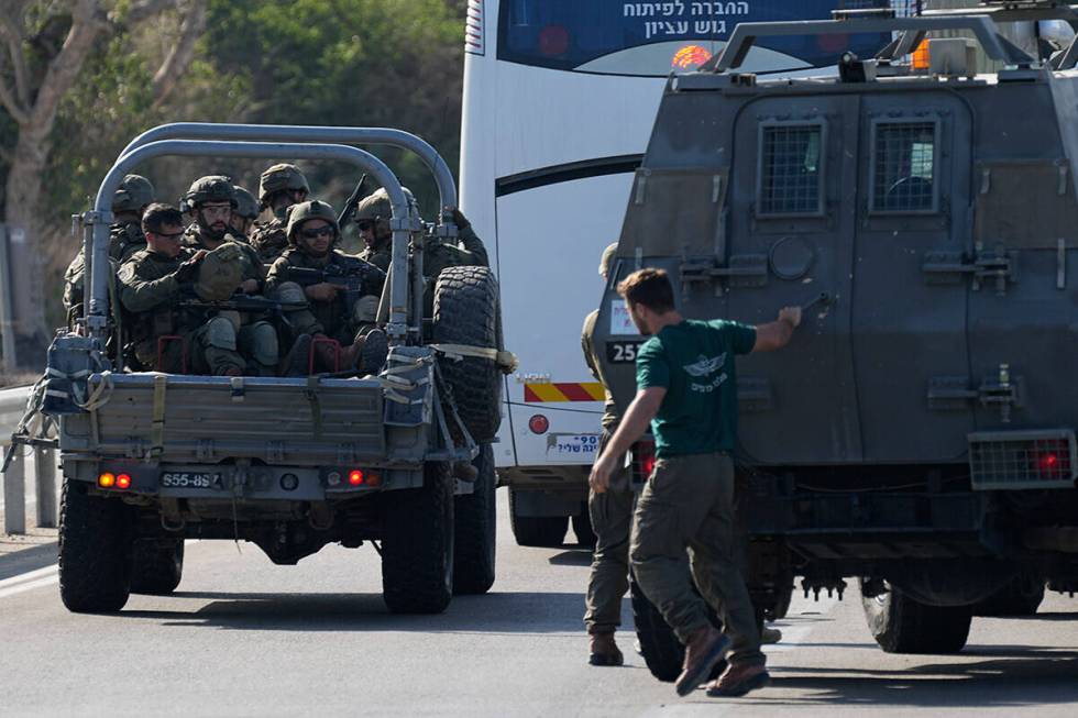 Israeli soldiers head south near Ashkelon, Israel, Israel, on Saturday, Oct. 7, 2023. Palestini ...