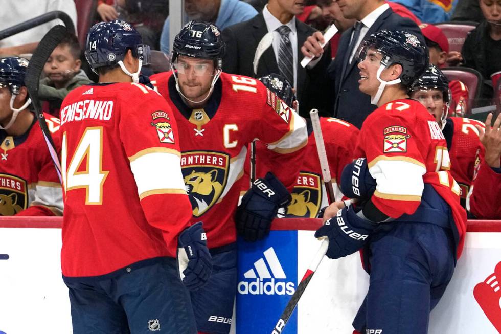 Florida Panthers forward Alexander Barkov (16) talks with forward Grigori Denisenko (14) and fo ...