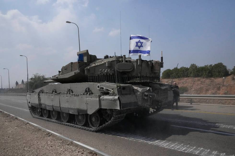 Israeli tank heads south near Sderot, Israel, Sunday, Oct.8, 2023. Hamas militants stormed over ...