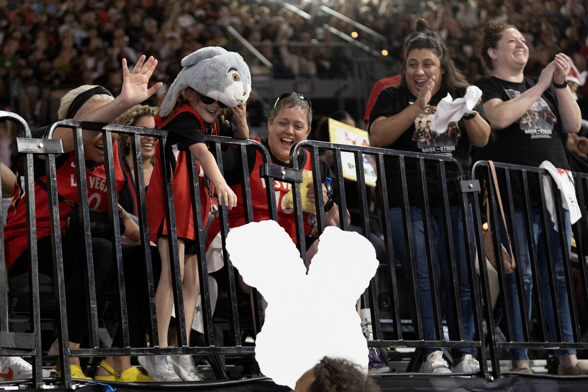A young Aces fan is given a prize during the second half in Game 1 of a WNBA basketball final s ...