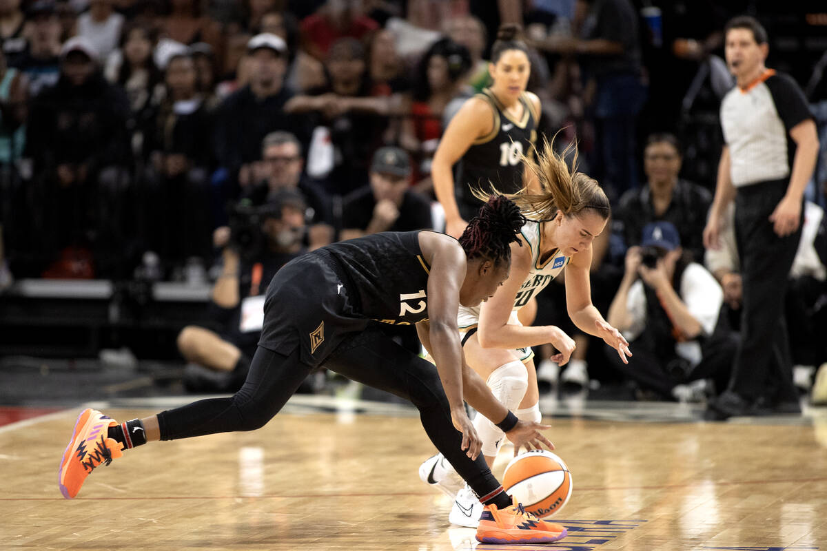 Las Vegas Aces guard Chelsea Gray (12) attempts to steal the ball from New York Liberty guard S ...