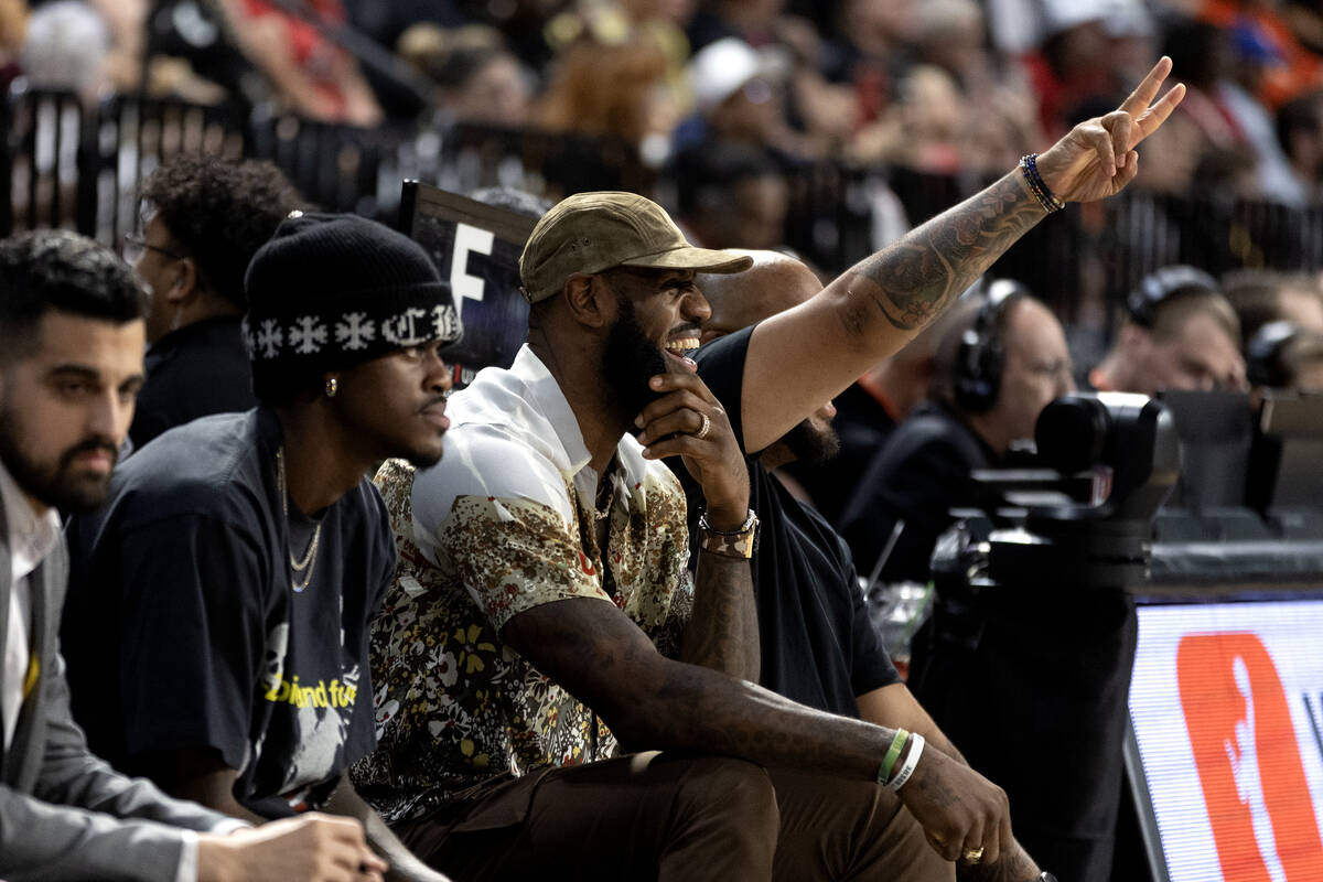 NBA superstar Lebron James laughs on the sidelines during the second half in Game 1 of a WNBA b ...