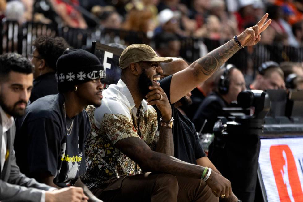 NBA superstar Lebron James laughs on the sidelines during the second half in Game 1 of a WNBA b ...
