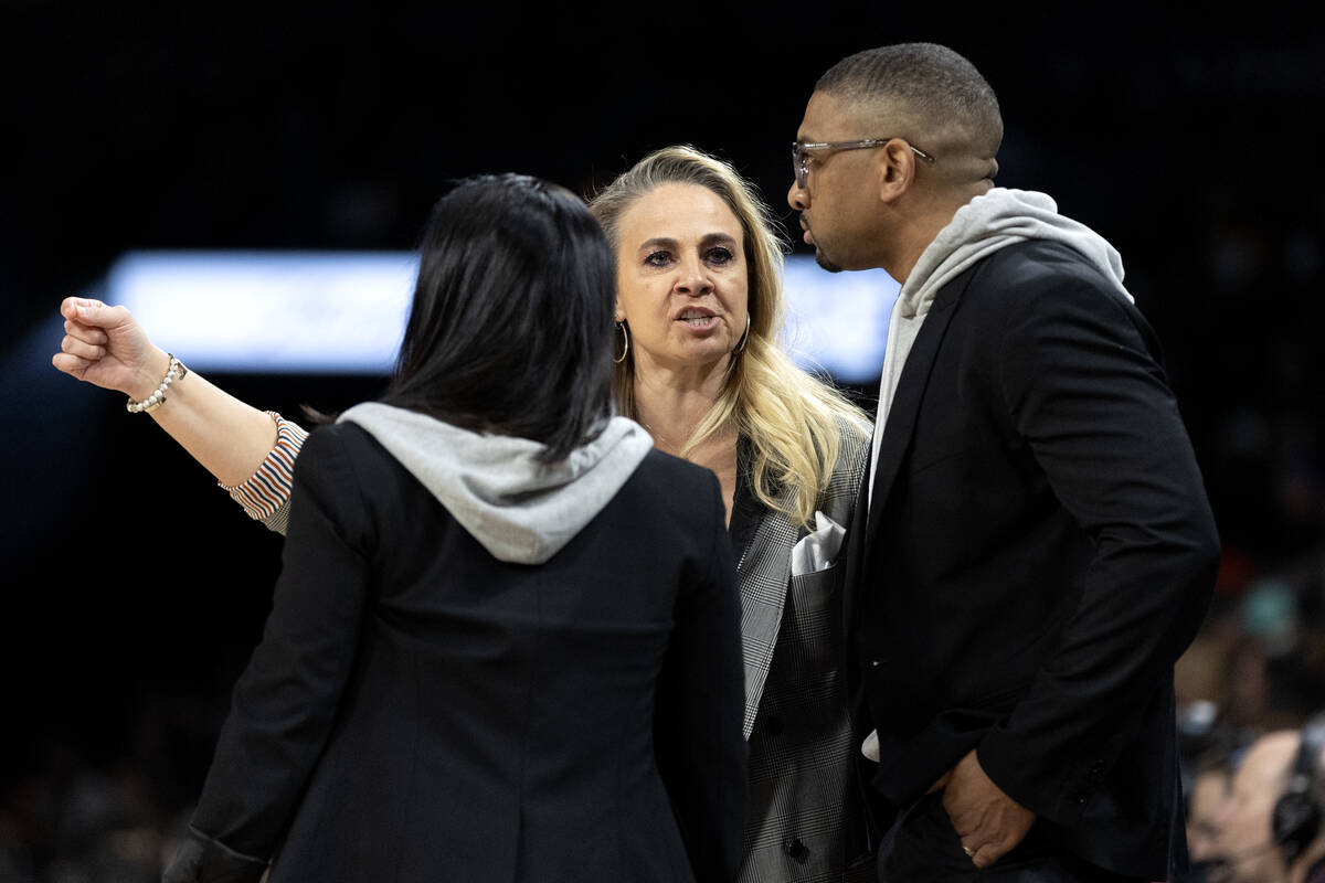 Las Vegas Aces head coach Becky Hammon confers with assistant coaches Natalie Nakase, left, and ...