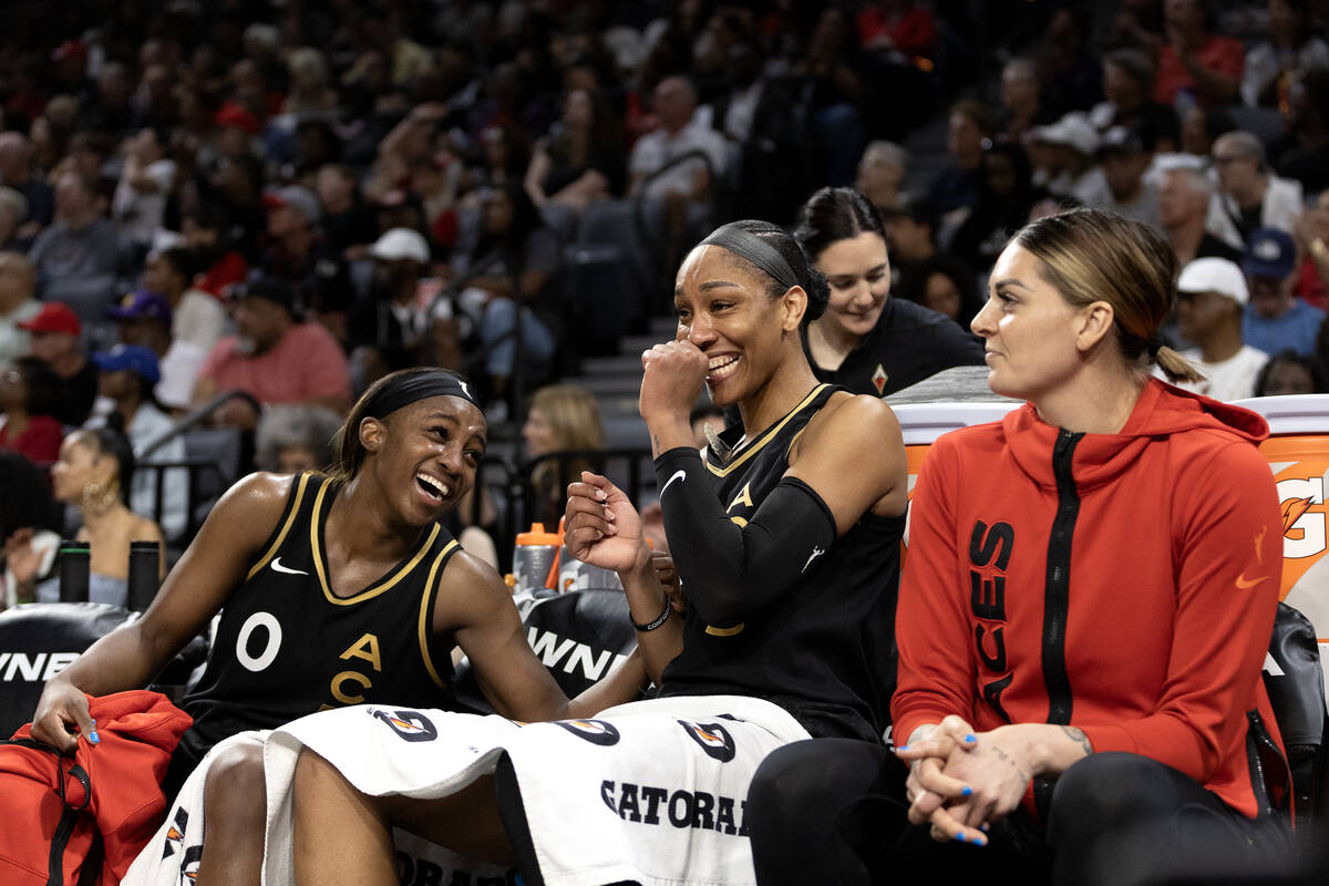 Las Vegas Aces guard Jackie Young (0) and forward A'ja Wilson (22) share a laugh while their be ...