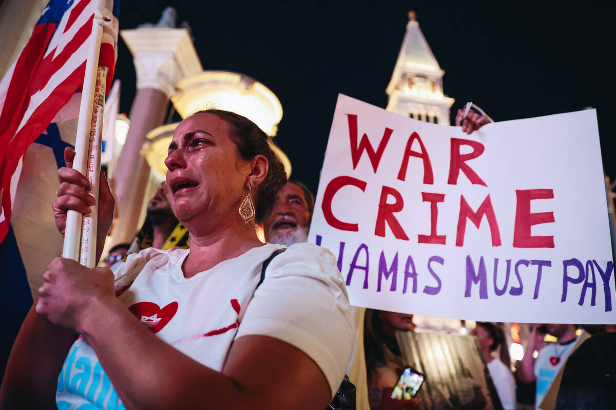 A woman cries during a pro-Israel rally outside the Venetian on Sunday, Oct. 8, 2023, in Las Ve ...