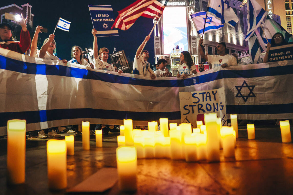 A vigil takes place during a pro-Israel rally outside the Venetian on Sunday, Oct. 8, 2023, in ...