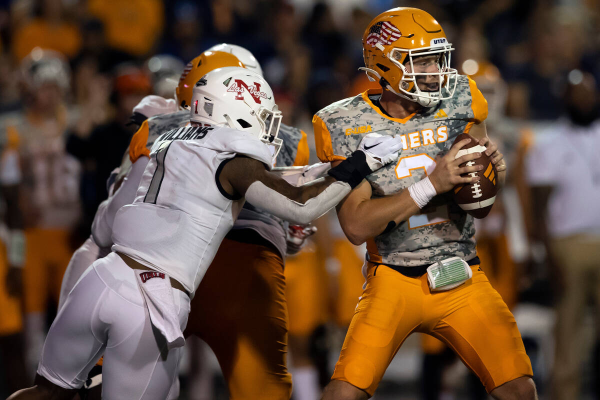 UTEP quarterback Gavin Hardison (2) tries to resist the tackle by UNLV defensive back Jerrae Wi ...