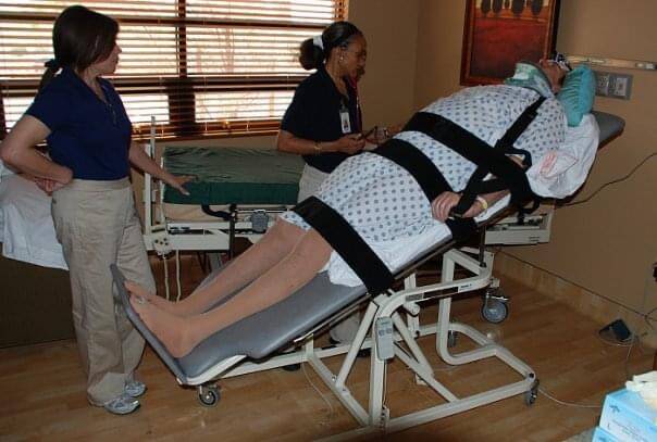 Scott Frost doing rehab on the tilt table. (Courtesy)