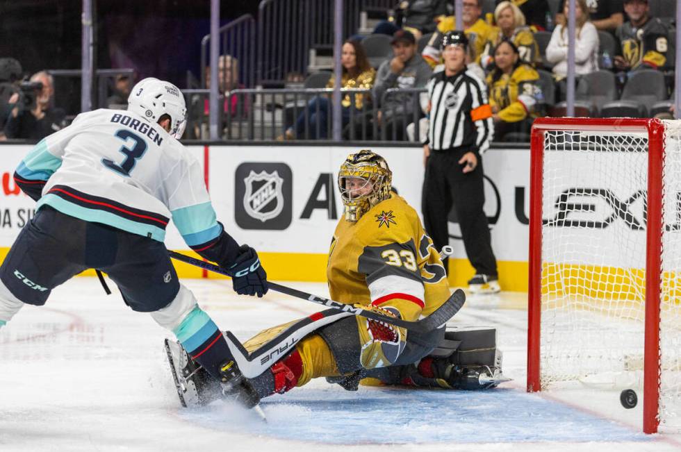 Golden Knights goaltender Adin Hill (33) watches the puck hit the post shot by Seattle Kraken d ...