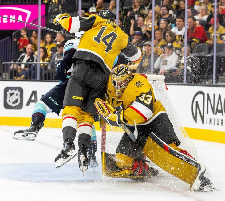 Golden Knights goaltender Adin Hill (33) defends the net as Seattle Kraken defenseman Vince Dun ...