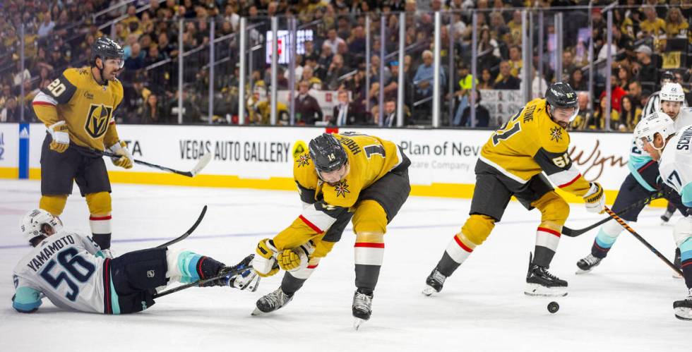 Golden Knights right wing Mark Stone (61) looks to control the puck as defenseman Nicolas Hague ...