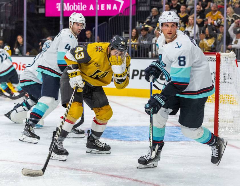 Golden Knights center Paul Cotter (43) grabs his face after a high stick by Seattle Kraken defe ...