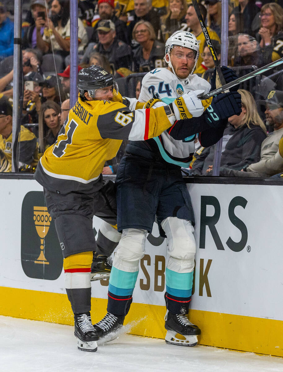 Golden Knights right wing Jonathan Marchessault (81) drives Seattle Kraken defenseman Jamie Ole ...