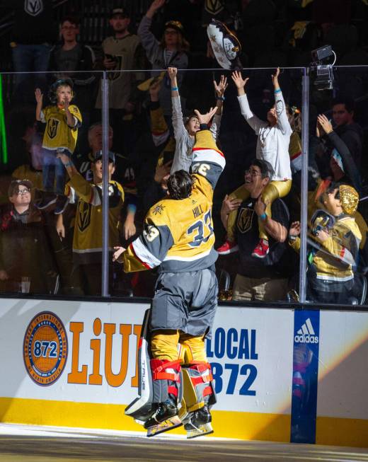 Golden Knights goaltender Adin Hill (33) tosses a pillow to a fan after their 4-1 win over the ...