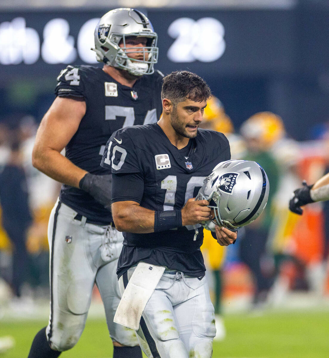 Raiders quarterback Jimmy Garoppolo (10) shakes off a hard sack from the Green Bay Packers defe ...
