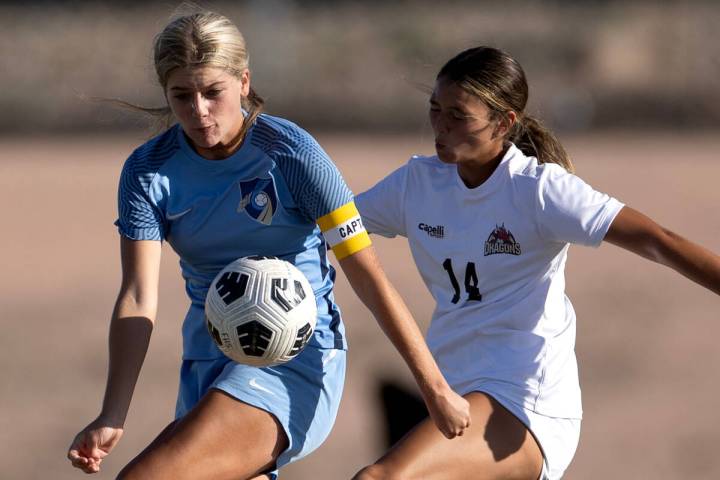 Foothill midfielder Tianna Hunsaker, center, bumps the ball forward while Doral center Peyton H ...