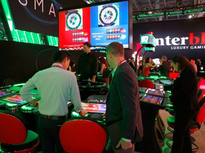 Conventioneers try out Interblock Gaming's Smart Pit Roulette at G2E Las Vegas at Sands Expo, o ...