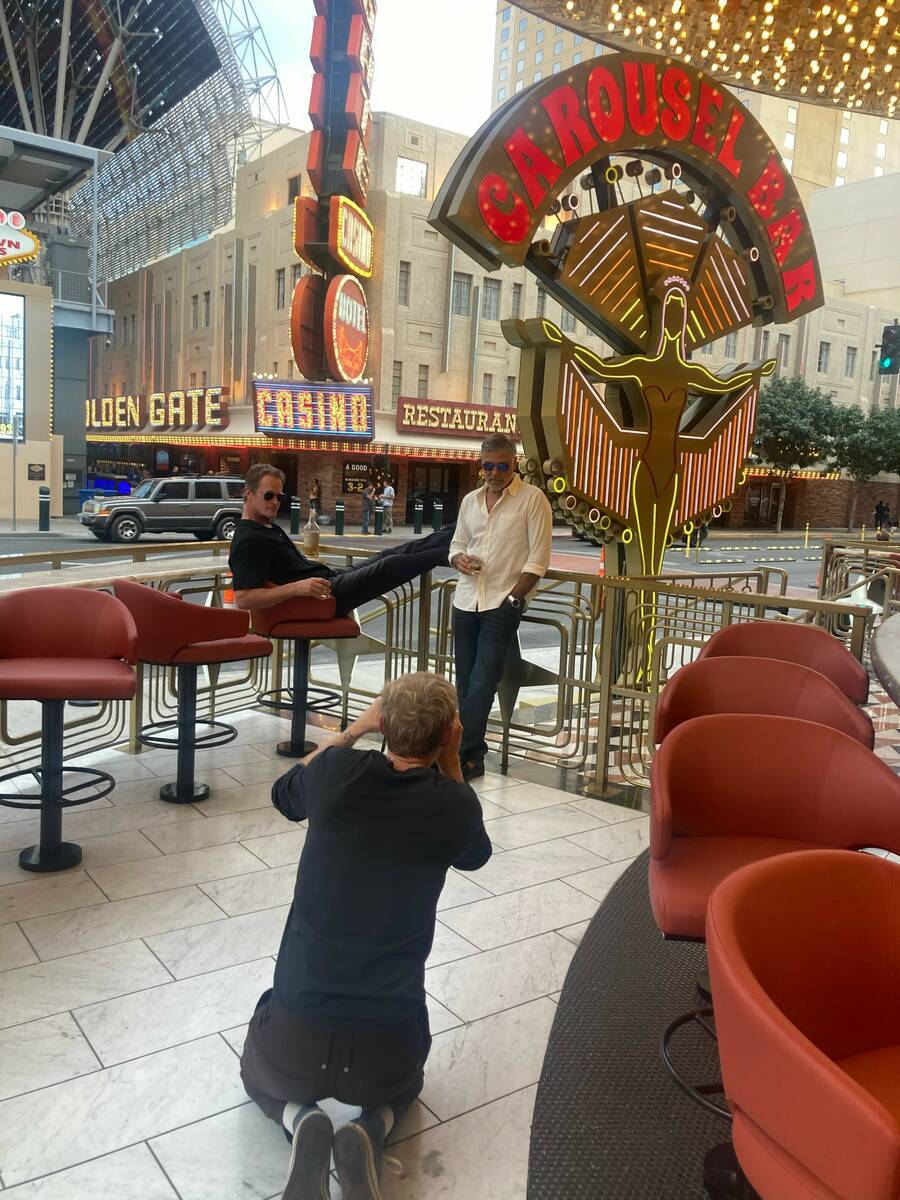 Rande Gerber and George Clooney are shown in a behind-the-scenes shot with photographer Jason L ...