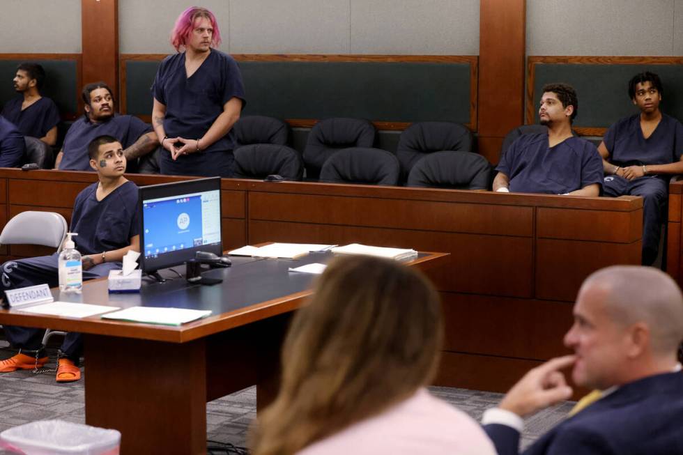 Jesus Ayala, 18, seated lower left, and Jzamir Keys, 16, right rear, wait to appear in court at ...