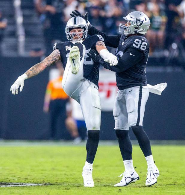 Raiders defensive end Maxx Crosby (98) celebrates a sack on Green Bay Packers quarterback Jorda ...