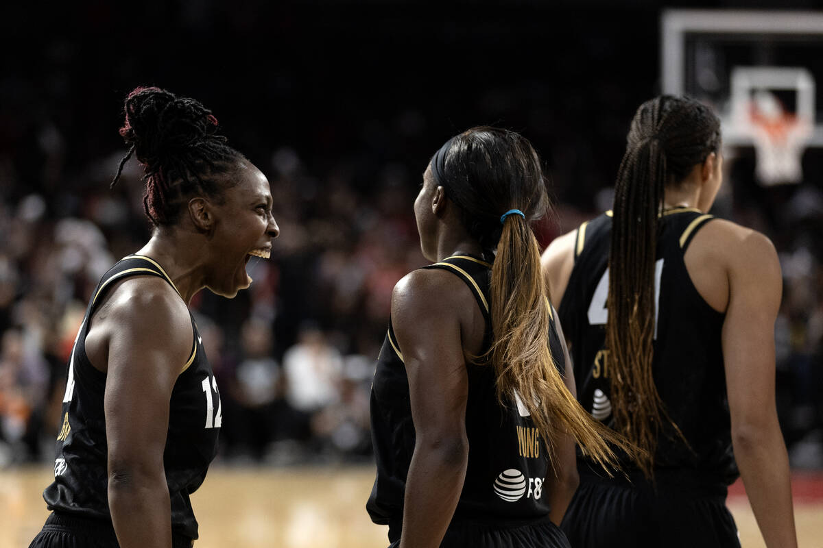Las Vegas Aces guard Chelsea Gray (12) screams in celebration for guard Jackie Young (0) after ...