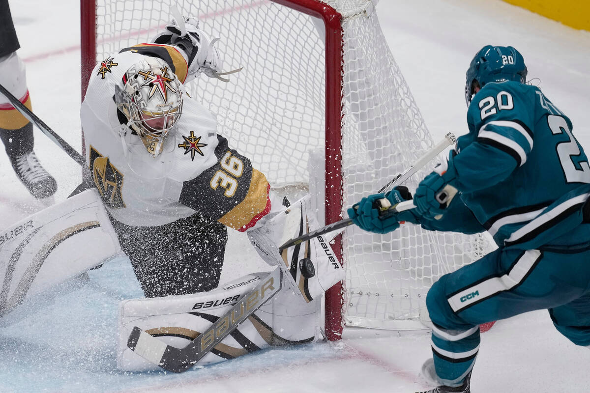 Vegas Golden Knights goaltender Logan Thompson (36) defends against a shot by San Jose Sharks l ...