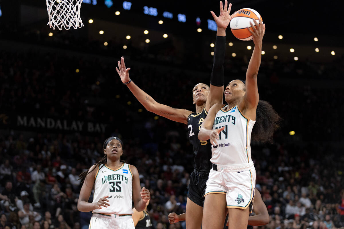 Las Vegas Aces forward A'ja Wilson (22) reaches to block against New York Liberty forward Betni ...