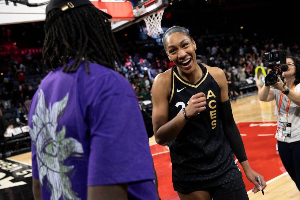 Las Vegas Aces forward A'ja Wilson (22) greets NBA player for the Philadelphia 76ers Montrezl H ...