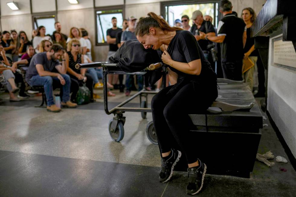 Mourners react beside the body of Mapal Adam, during her funeral in Tel Aviv, Israel, Wednesday ...