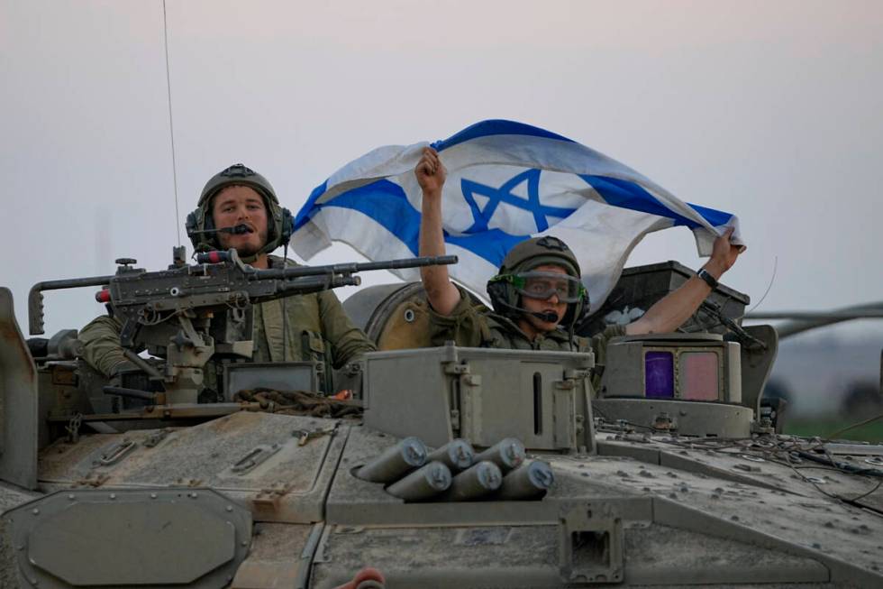 Israeli tanks head towards the Gaza Strip border in southern Israel on Thursday, Oct.12, 2023. ...