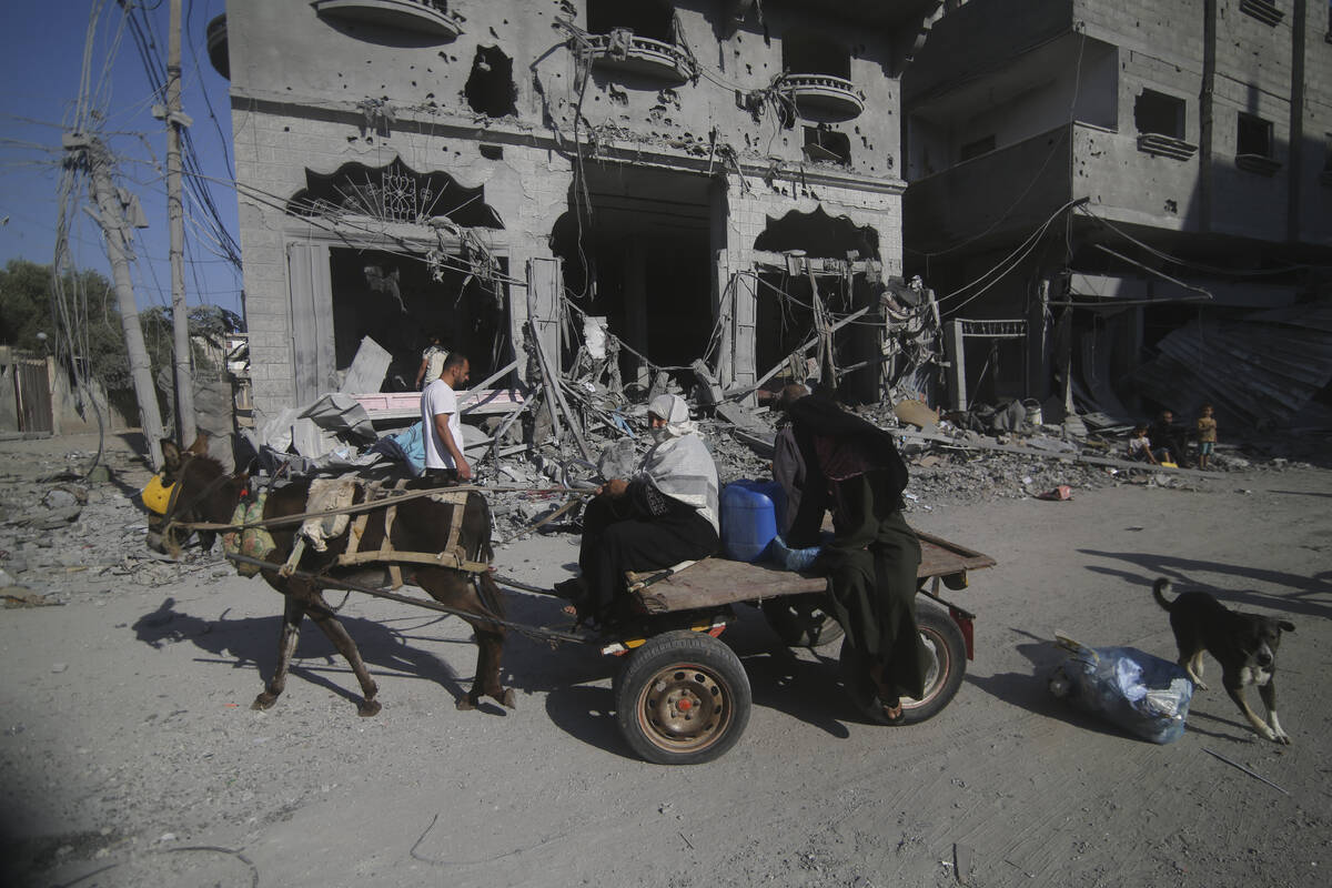 Palestinians leave their houses following Israeli airstrikes in Rafah refugee camp, southern Ga ...