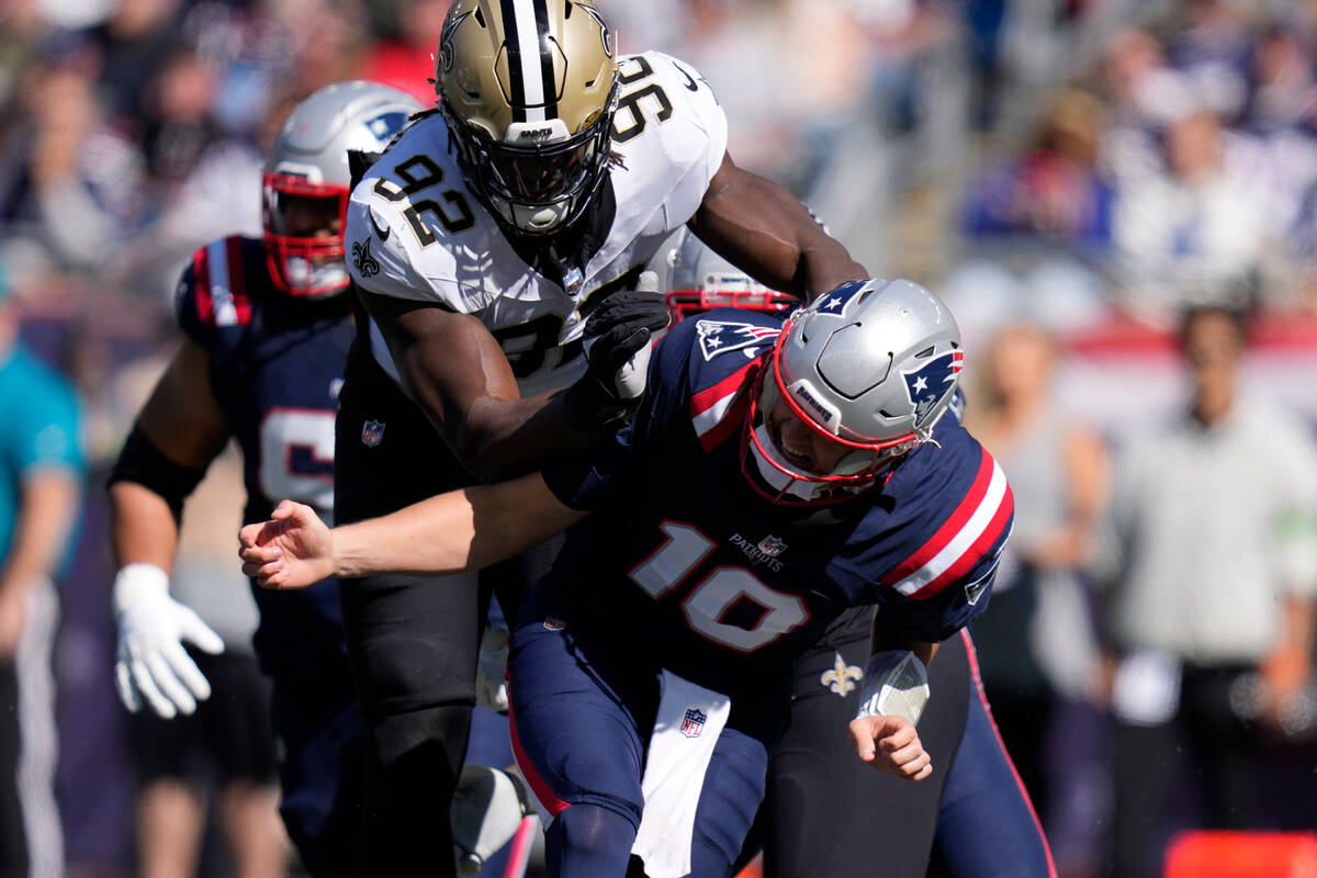 New Orleans Saints defensive end Tanoh Kpassagnon (92) hits New England Patriots quarterback Ma ...